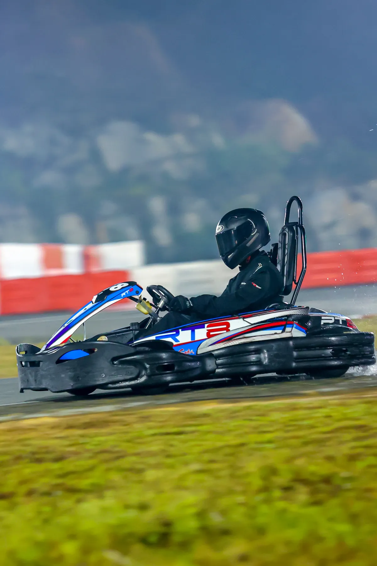 Driver in racing suit and helmet in the pit lane before an endurance race