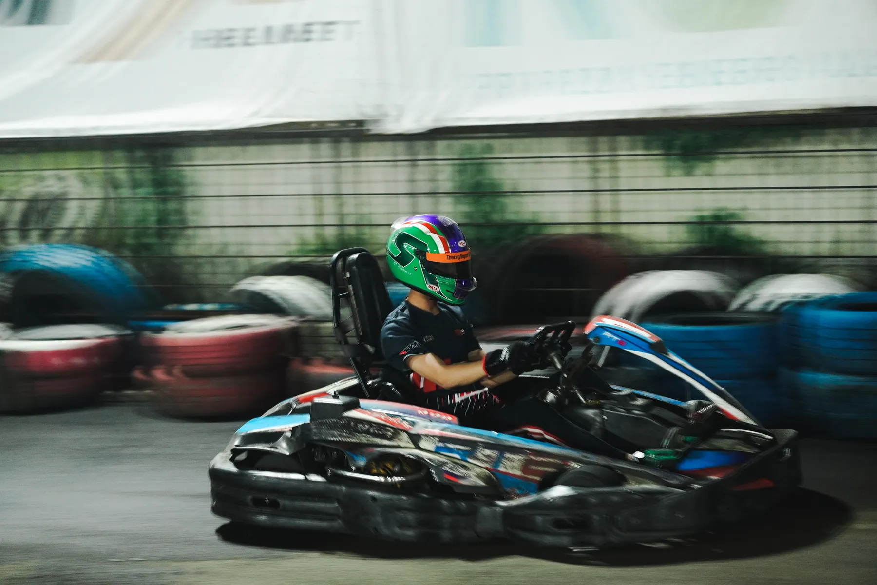 Kart cornering at night under floodlights